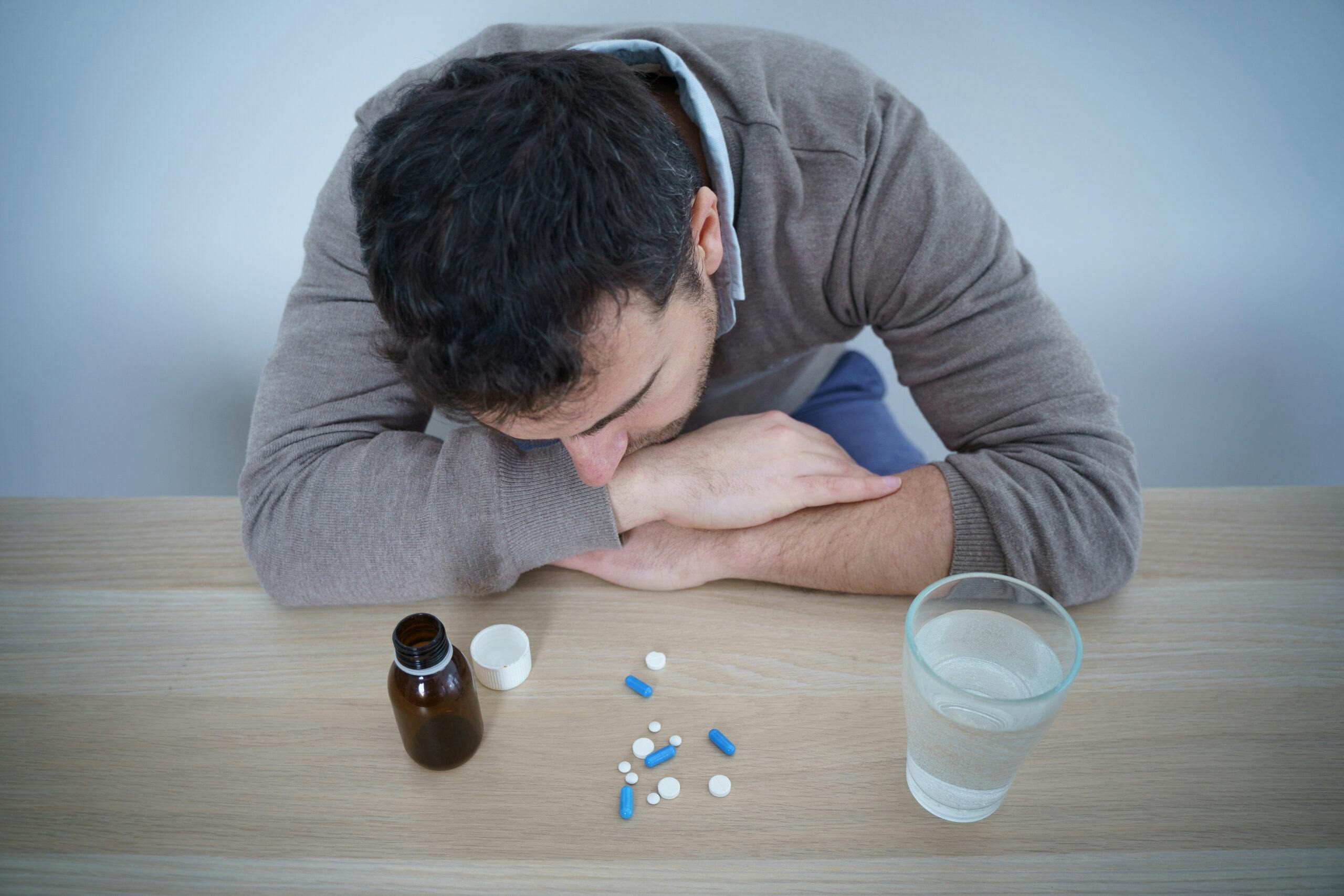 depressed man zoloft pills water
