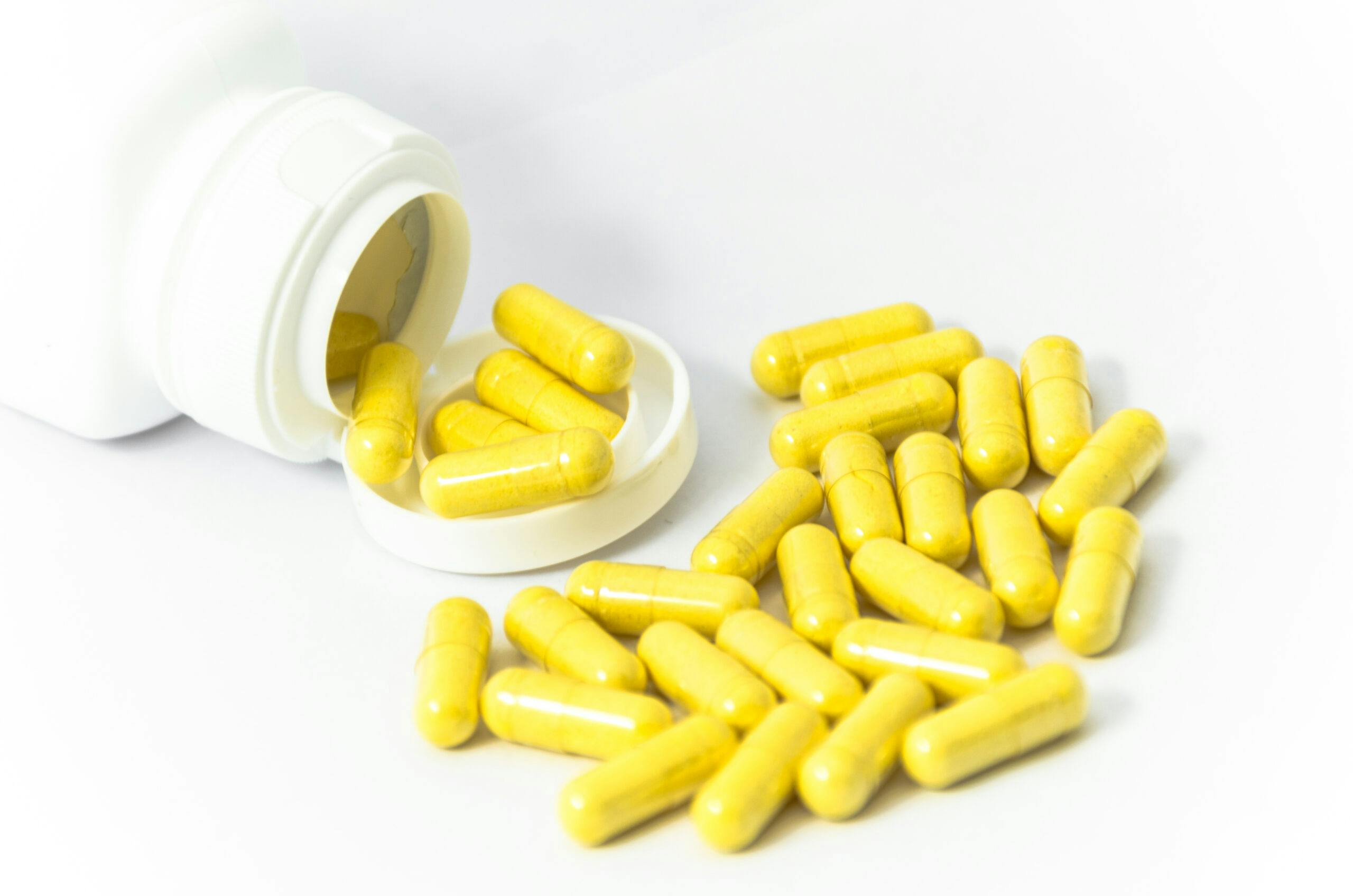 yellow capsule pills and bottle