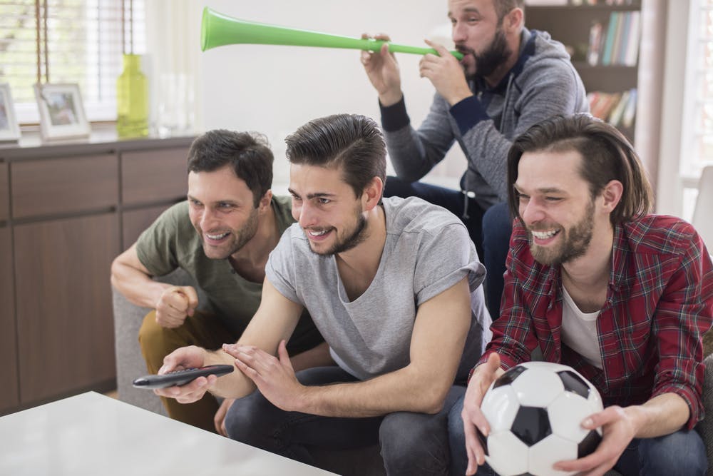 group of men watching soccer