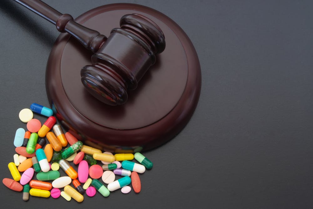 wooden gavel with multicolor pills