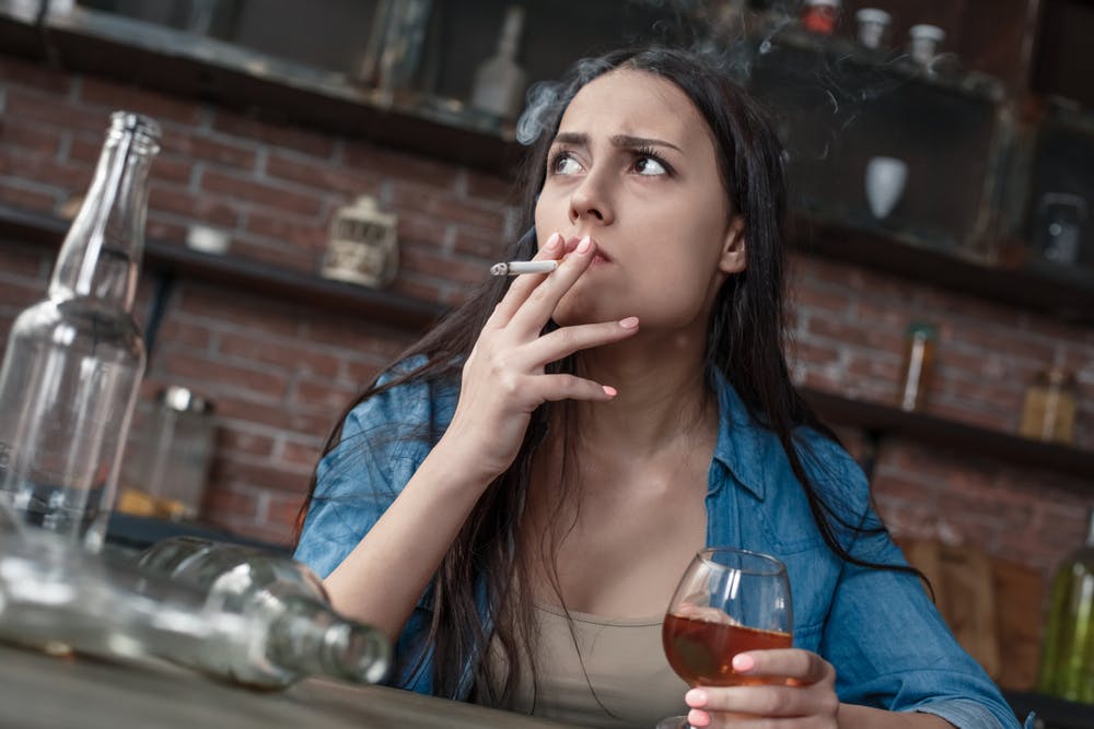 woman smoking cigarette drinking liquor
