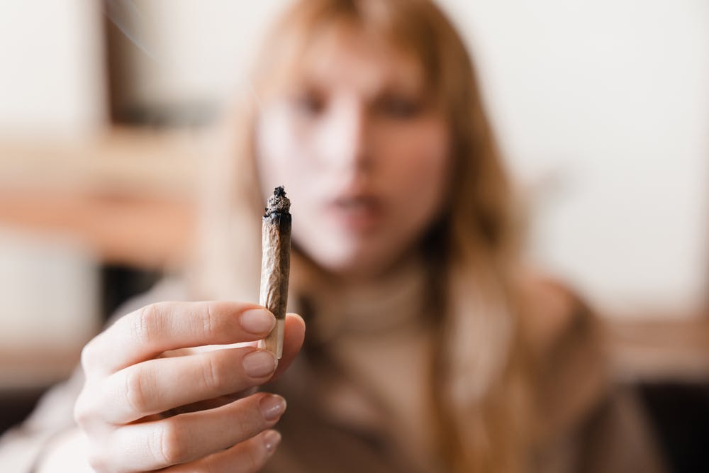 stoned woman with marijuana joint