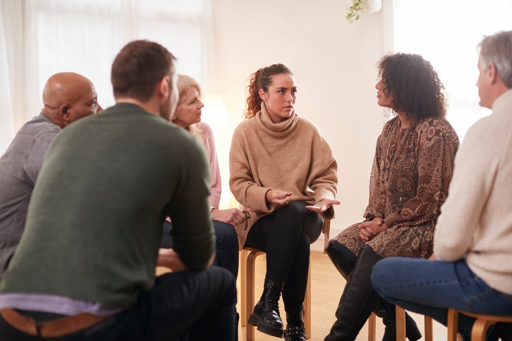 woman speaking at support group