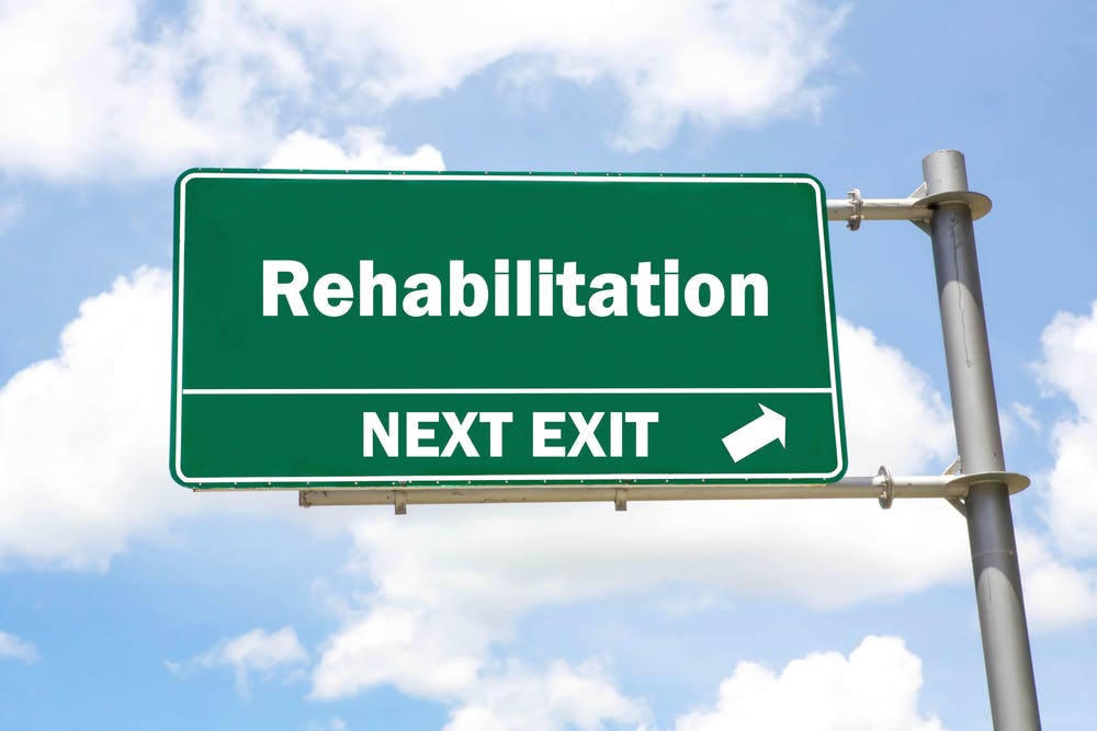 rehabilitation road sign next exit