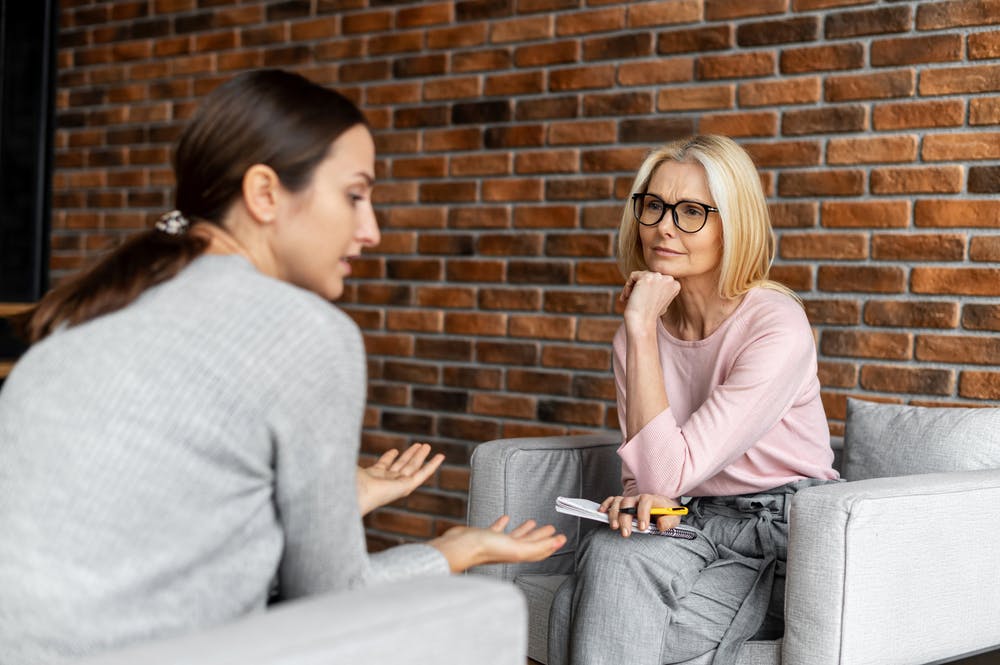 young woman talking with therapist