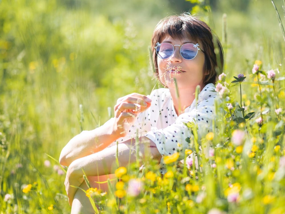 woman content in field of flowers