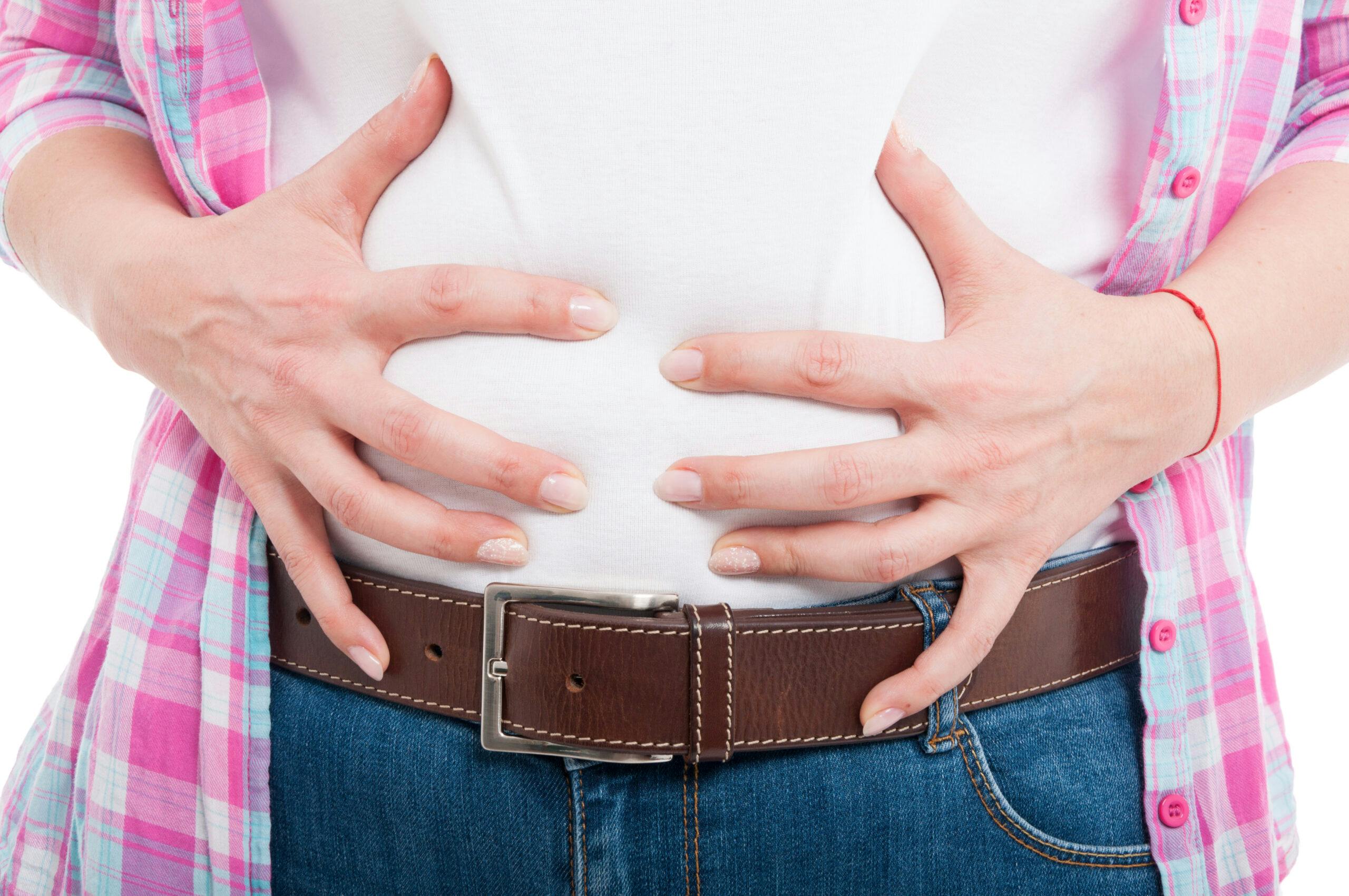woman bloated from drinking alcohol holding stomach