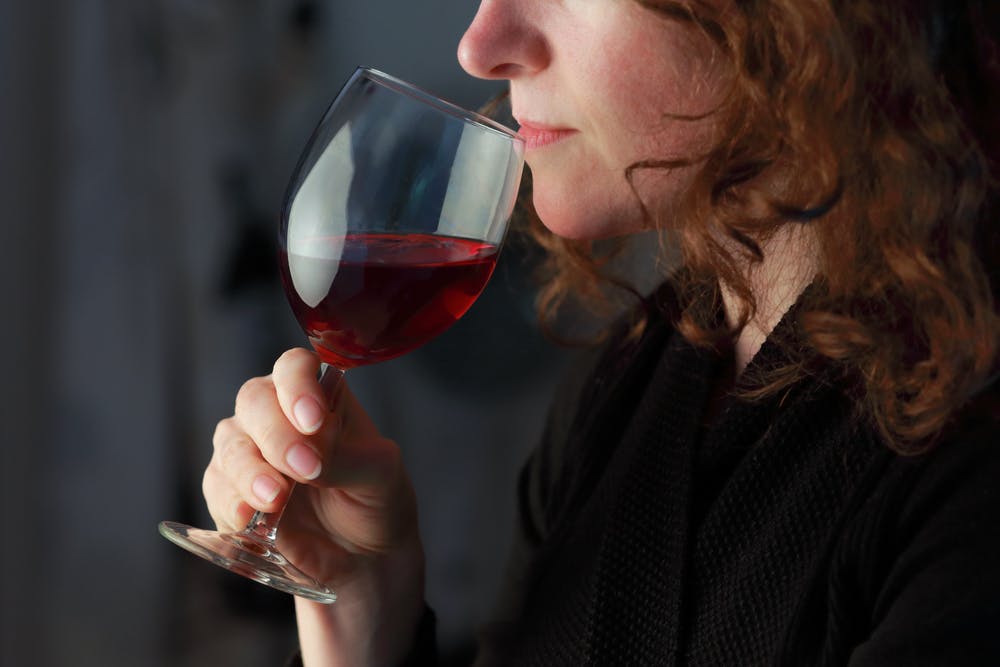 redhead woman drinking wine