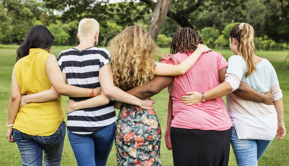 group hug outside women sober living