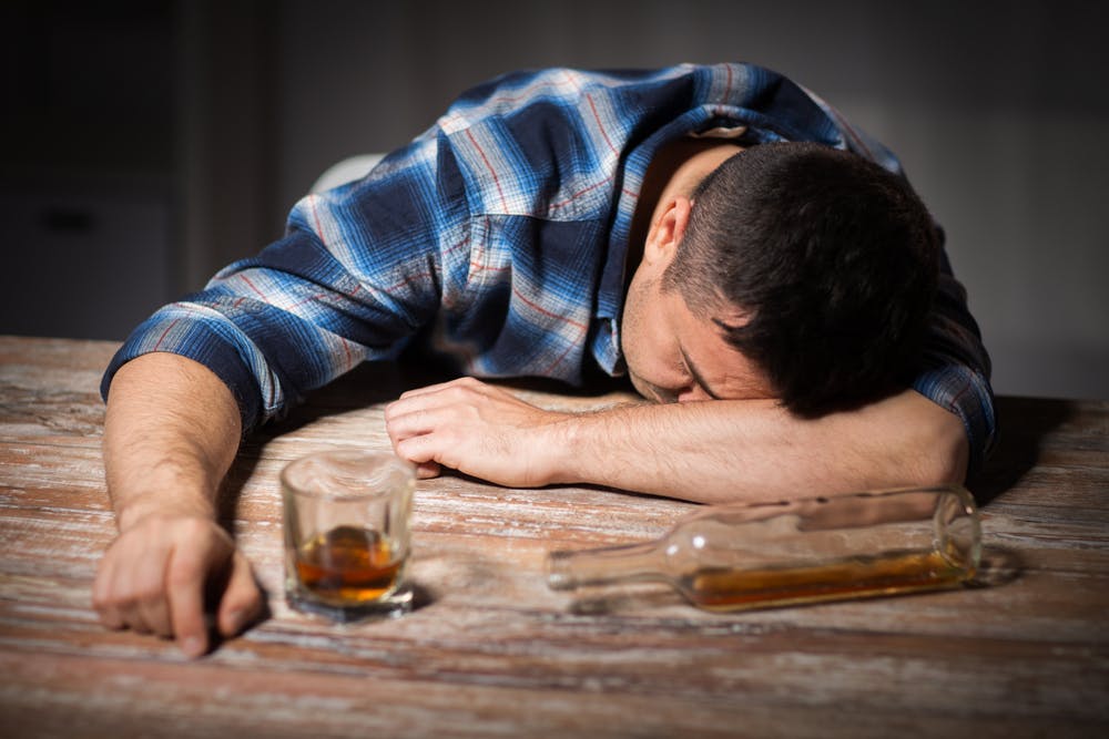man alcoholic drinking passed out