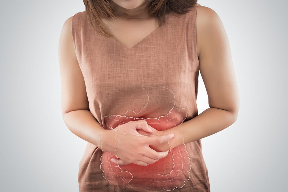 woman holding stomach constipated