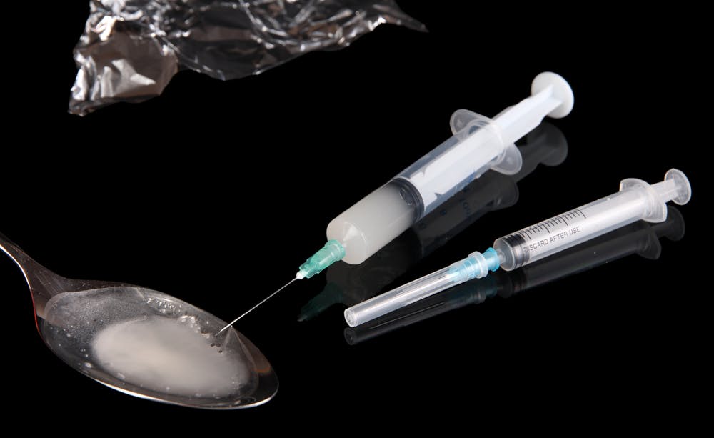 liquid meth in spoon with needles