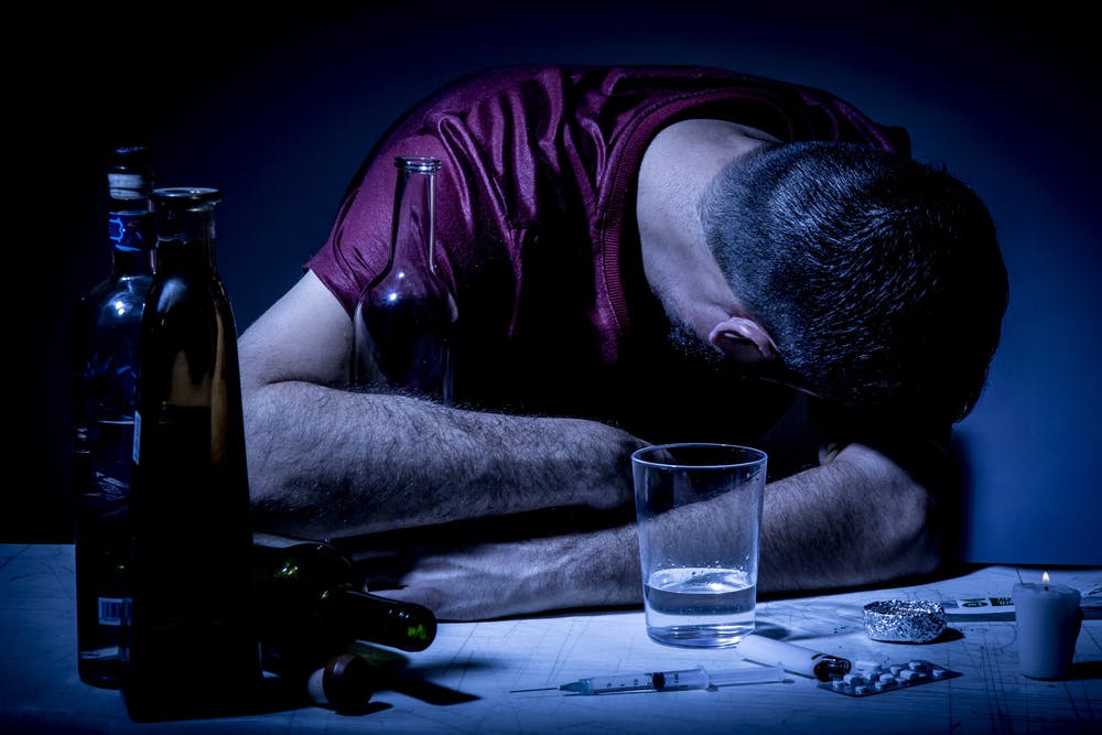man addict passed out drinking needle