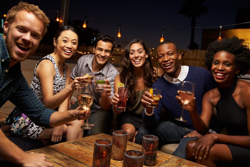group drinking alcohol in bar
