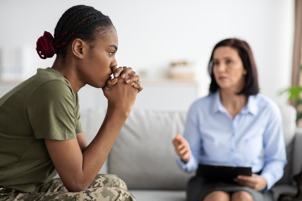 upset black woman military member with counselor