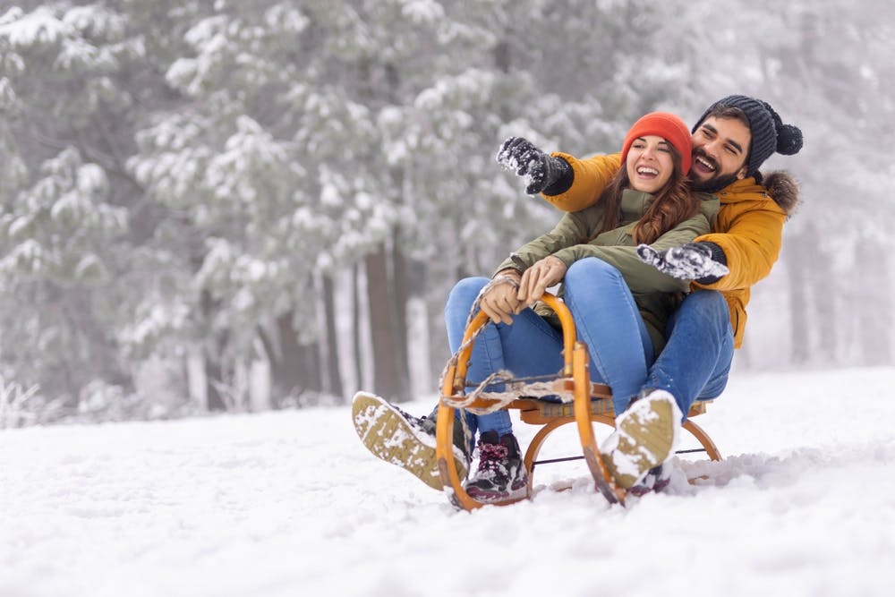 young couples spending winter vacation in mountains